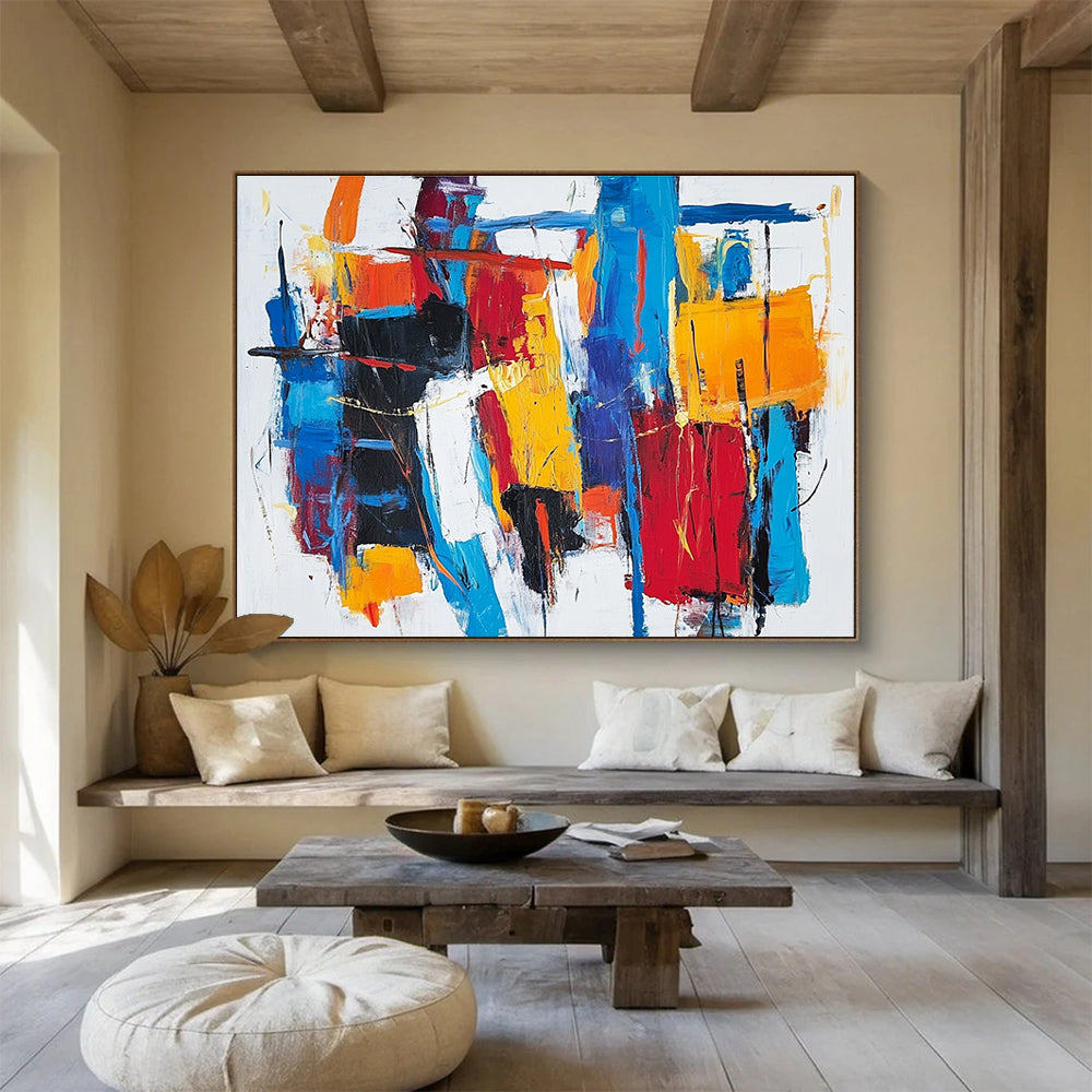 Large abstract painting with thick brush strokes and vibrant reds blues and yellows creating a unique abstract cityscape on a white background.SC262