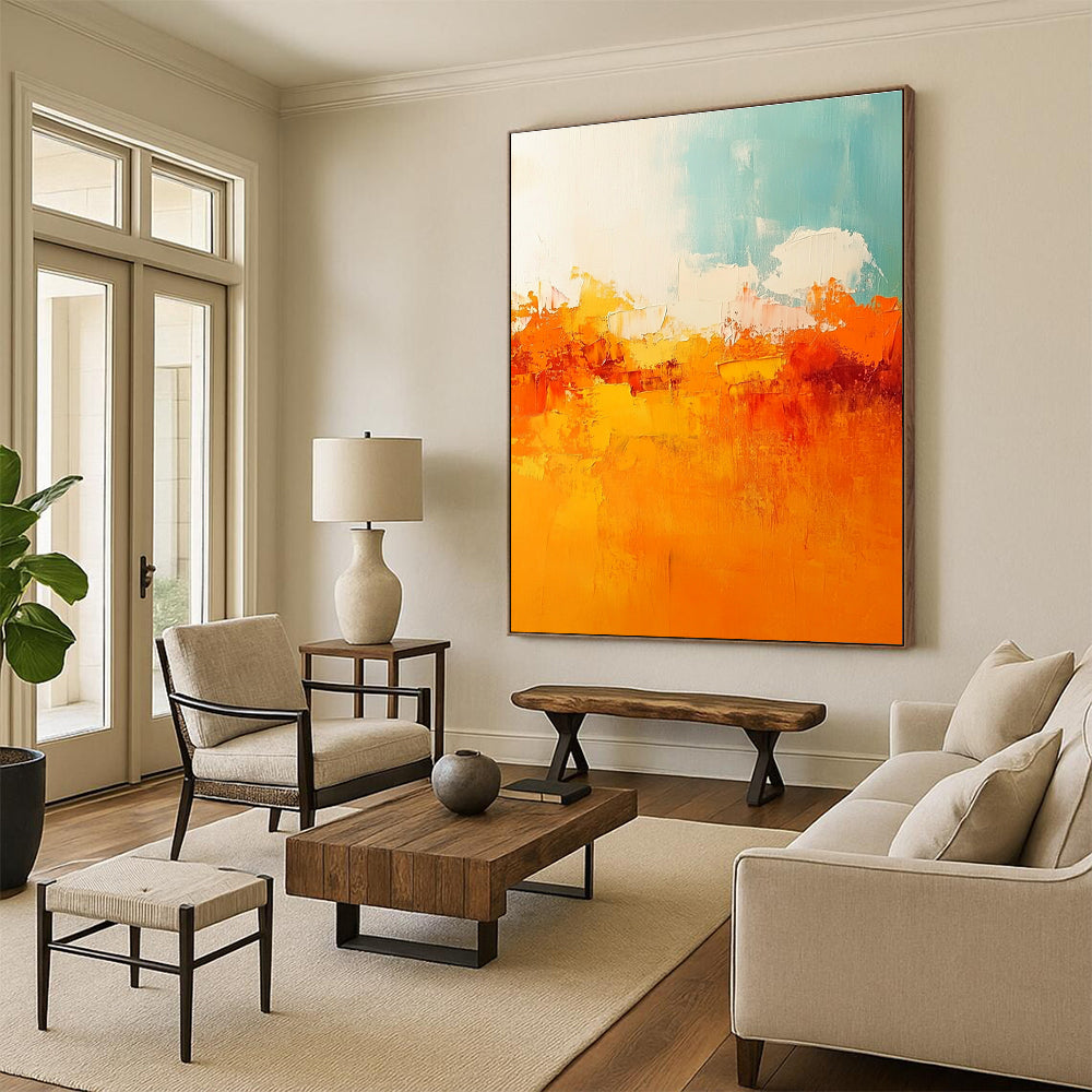Large abstract painting featuring warm tones of orange and yellow with soft edges and brushstrokes depicting a serene sunset sky.STSC119