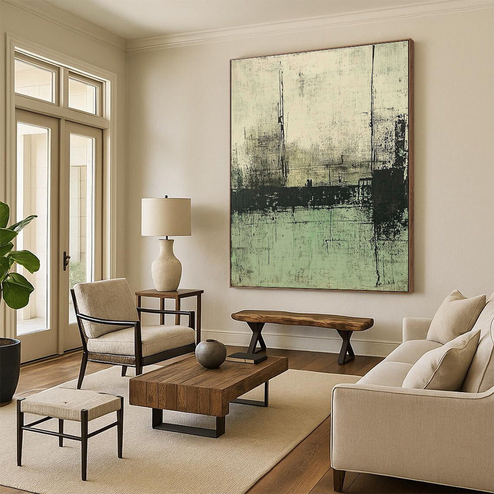 Large abstract painting featuring muted green and gray tones depicting a desolate landscape with distant buildings and water.STSC421