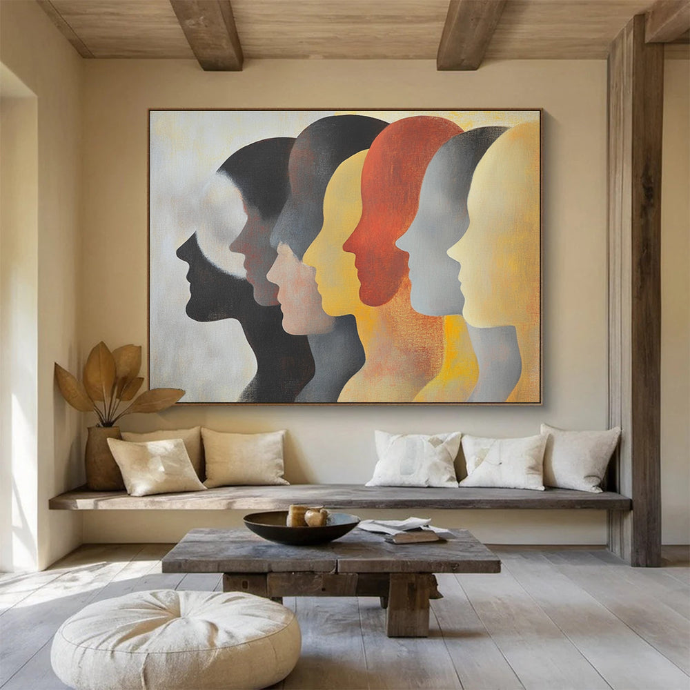 Large abstract painting featuring faces in profile with diverse skin tones and hairstyles in soft colors on a light background.SC548