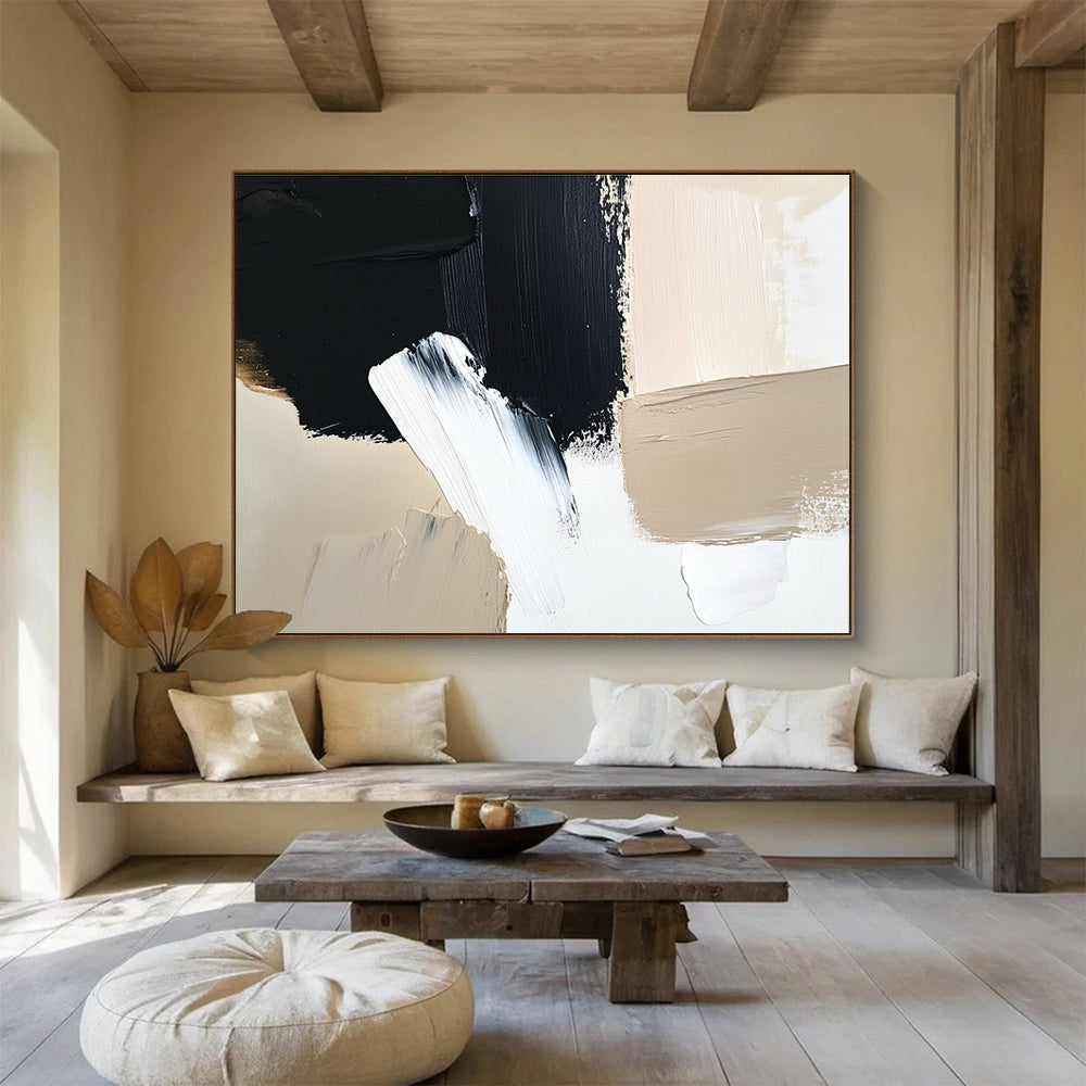 Large abstract painting featuring black brush strokes on a white background complemented by a minimalist beige and cream color palette.SC012