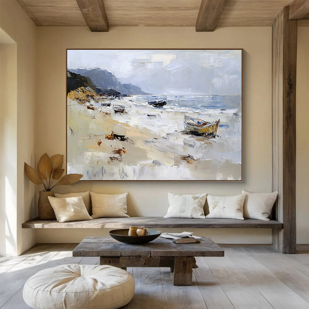 Large abstract oil painting of a beach with loose brush strokes featuring white gray and brown colors and visible sea spray and mountains in the background.SC605