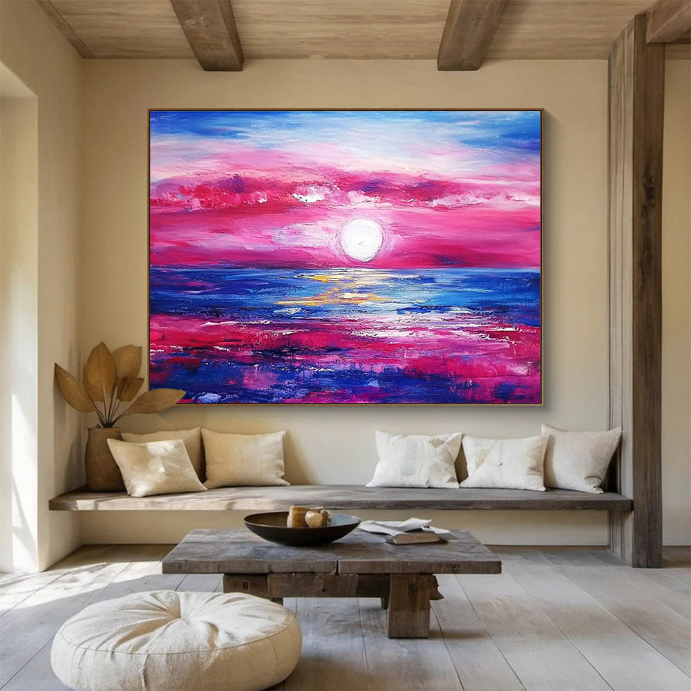 A large abstract painting featuring a pink and blue sunset over the ocean with purple and red clouds by artist Anna Bocek.SC537