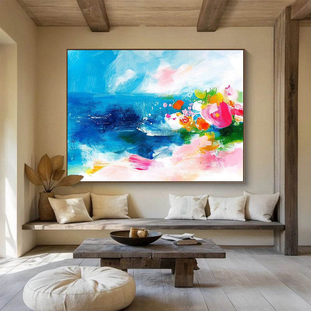 Large abstract painting of the ocean featuring bold brush strokes in pink blue green and orange with small flowers on a textured white background.SC363