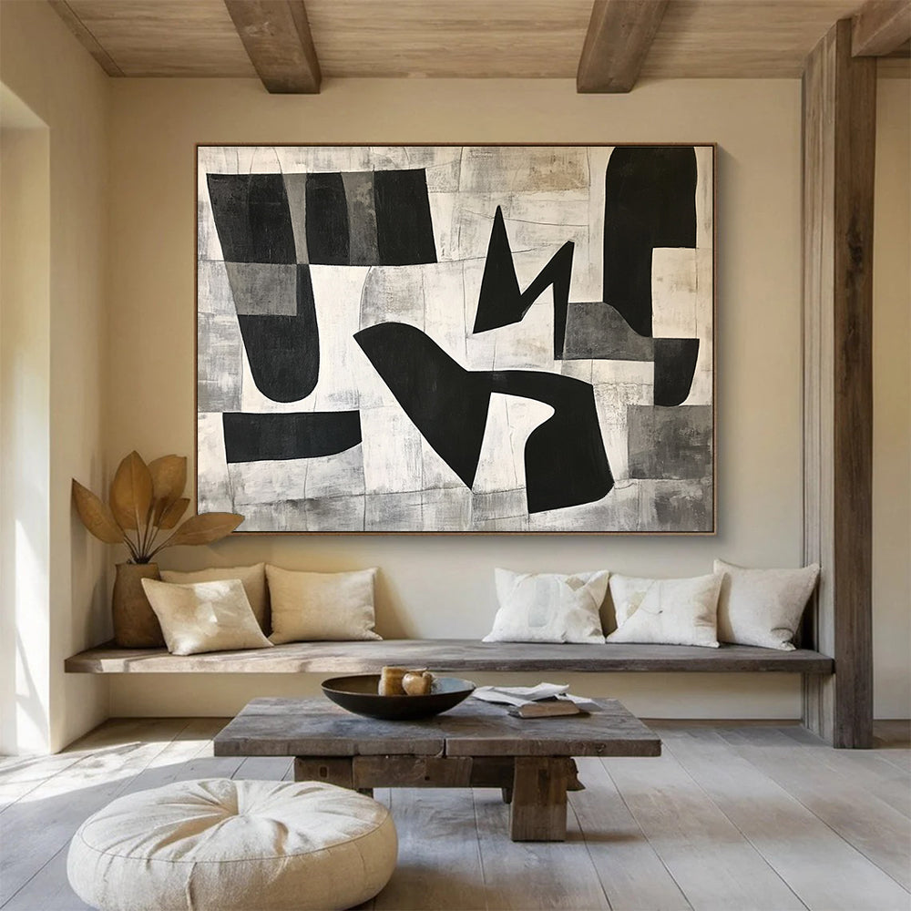 Large abstract painting featuring black and white geometric shapes in the letter K on a textured minimalist background conveying depth and movementSC517