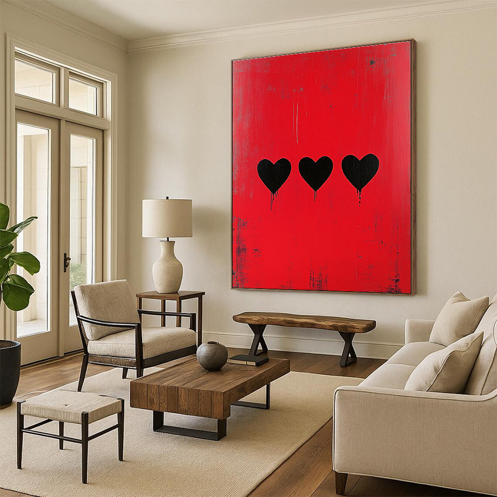 Large abstract painting with a striking red background featuring three bold black hearts in a style reminiscent of Banksy.STSC1164