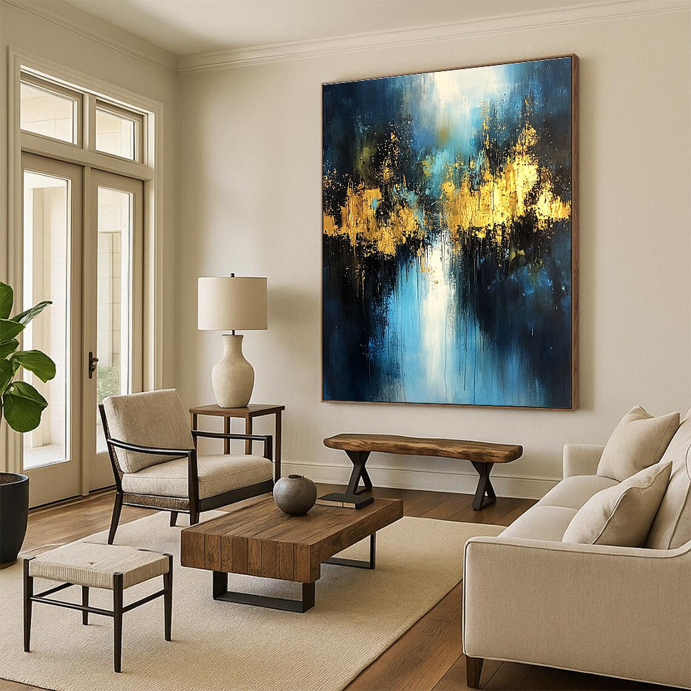 Large abstract painting with light blue and dark gold colors featuring atmospheric brushstrokes gold foil embellishments and a mysterious night scene.STSC399