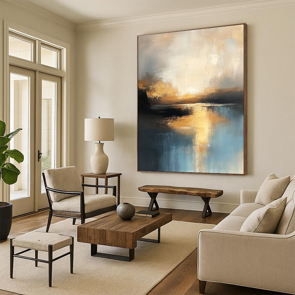 Large abstract oil painting of the sea in muted light blue and dark beige hues capturing the golden hour with textured brushstrokes and reflective water.STSC198