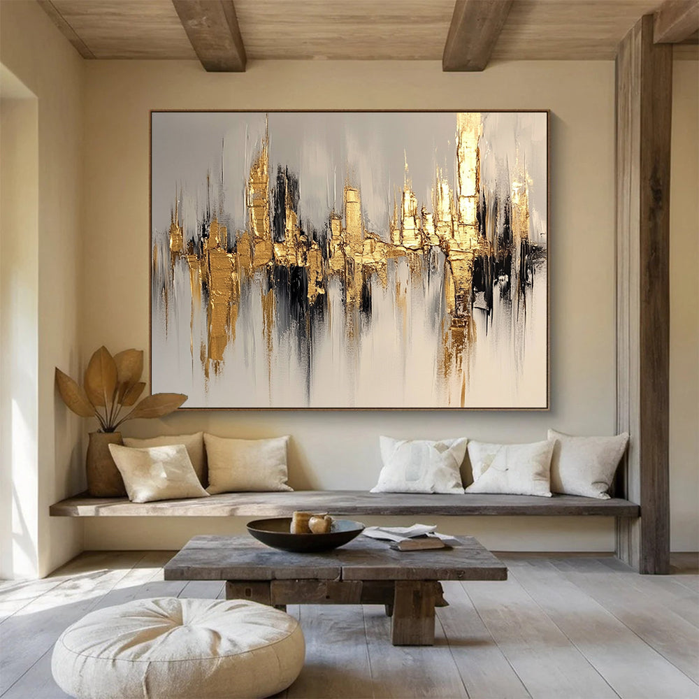 Large abstract painting of a cityscape in gold and white, featuring bold brush strokes on a white background with neutral tones.SC170
