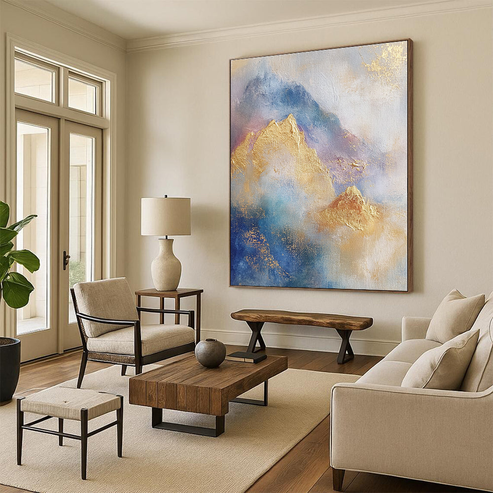 Large abstract painting featuring soft blue and gold tones with gilded mountains and textured brushstrokes for a striking visual impact.STSC446