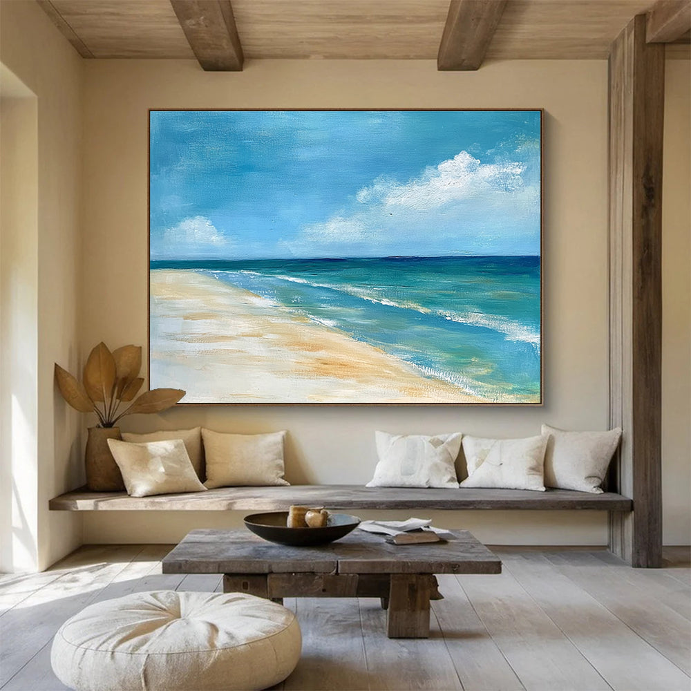 A large abstract painting of the ocean sky and sandy beach in muted blue tones with green accents and soft clouds for a serene ambiance.SC362