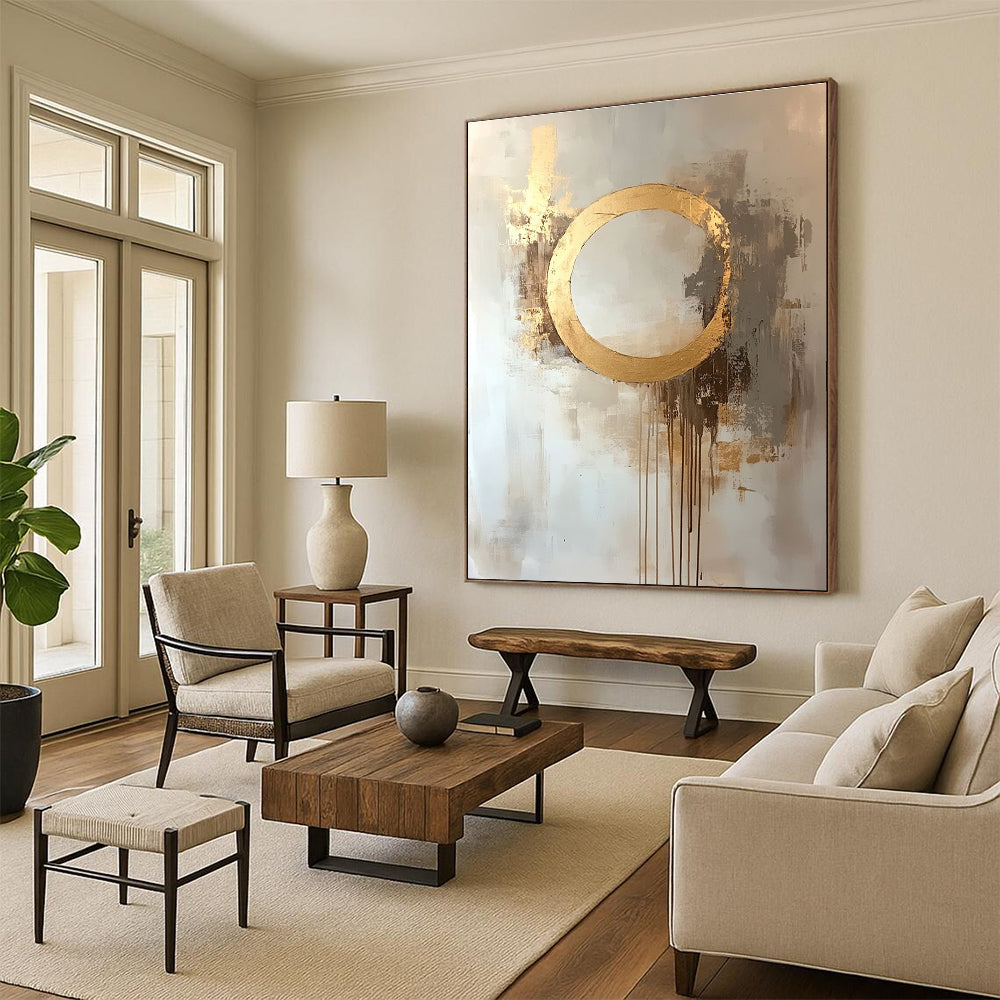 Large abstract oil painting featuring a moon with a golden circle in beige and gold tones with dripping gold leaf on a white background.STSC170