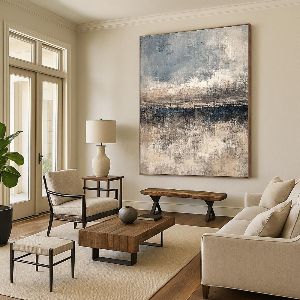 Large abstract painting featuring textured layers in neutral beige and gray with subtle blue and white accents creating depth and a serene horizon line.STSC108