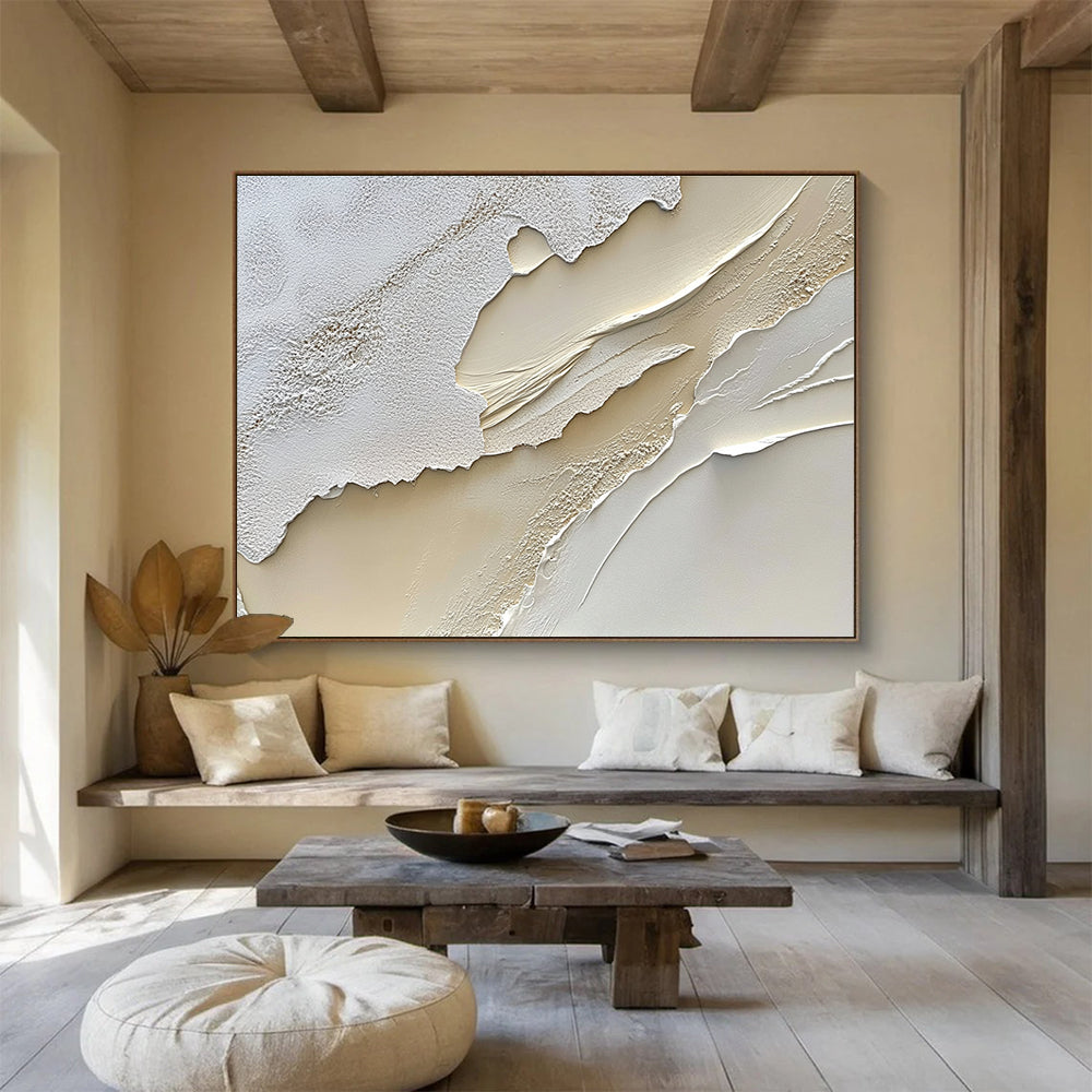 An abstract painting featuring a textured cream-colored surface reminiscent of sand dunes in soft white and beige tones.SC459