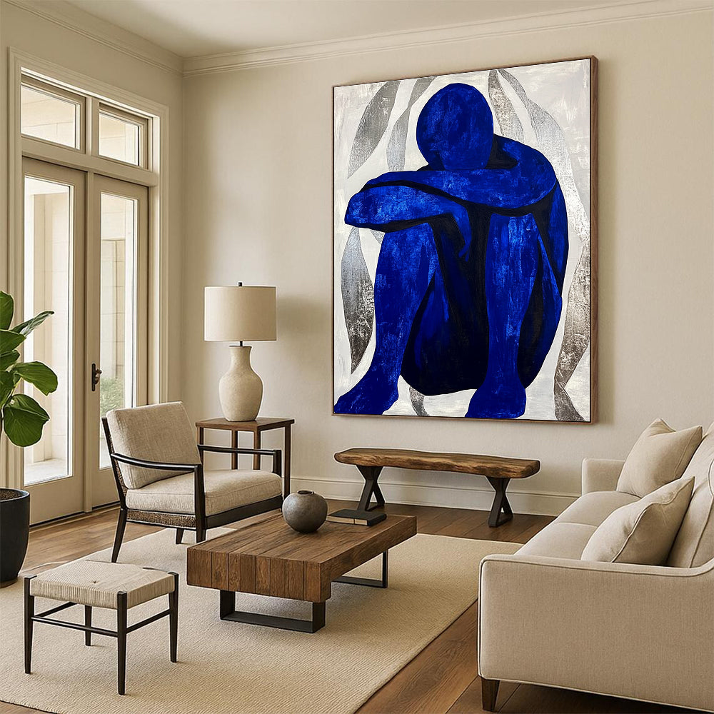 Large abstract painting featuring a contemplative blue figure amidst silver swirls, evoking tranquility and focus in a minimalist style.STSC922