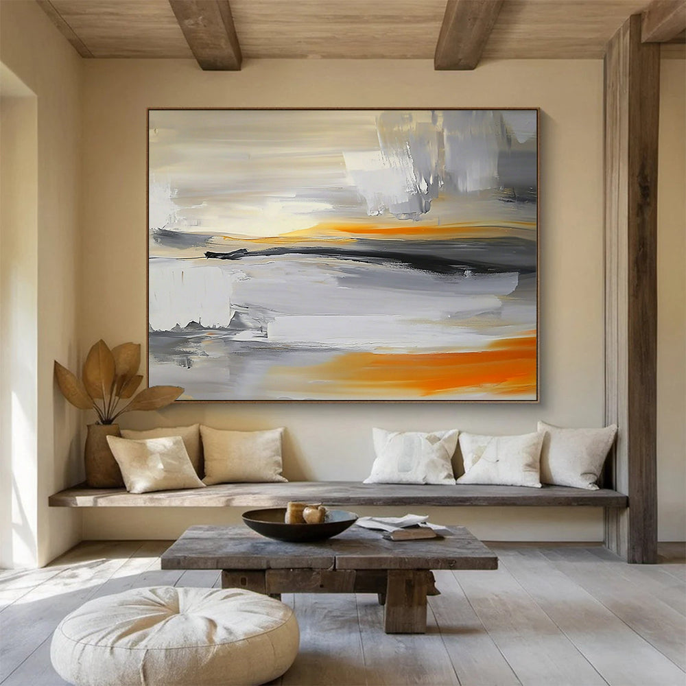 Large abstract painting featuring a grey, white, and orange sky with a blurred horizon and rocks below in a minimalist style.SC175
