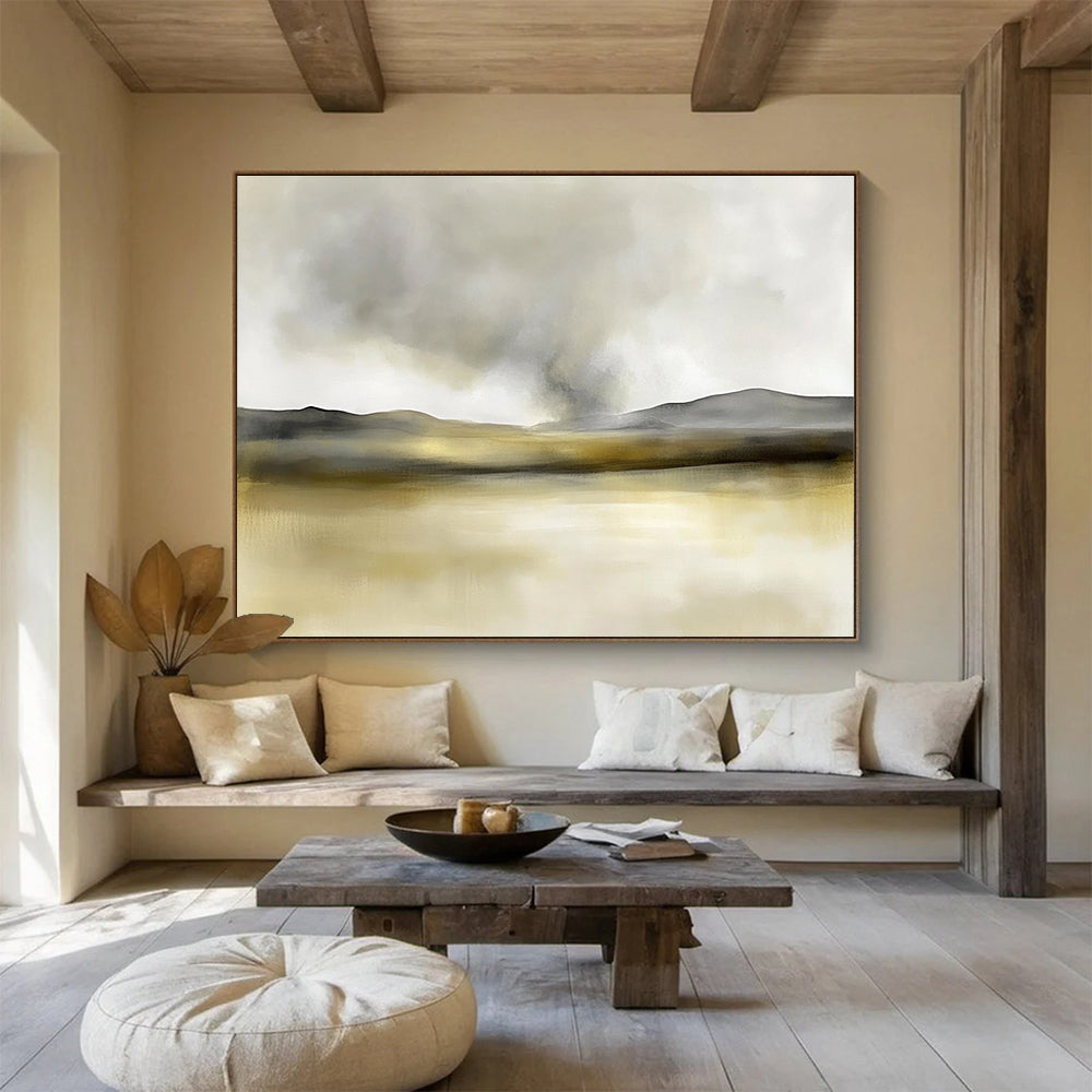 Large abstract painting in soft watercolors featuring neutral beige and gray tones with yellow accents and distant rolling hills under smoke.SC075