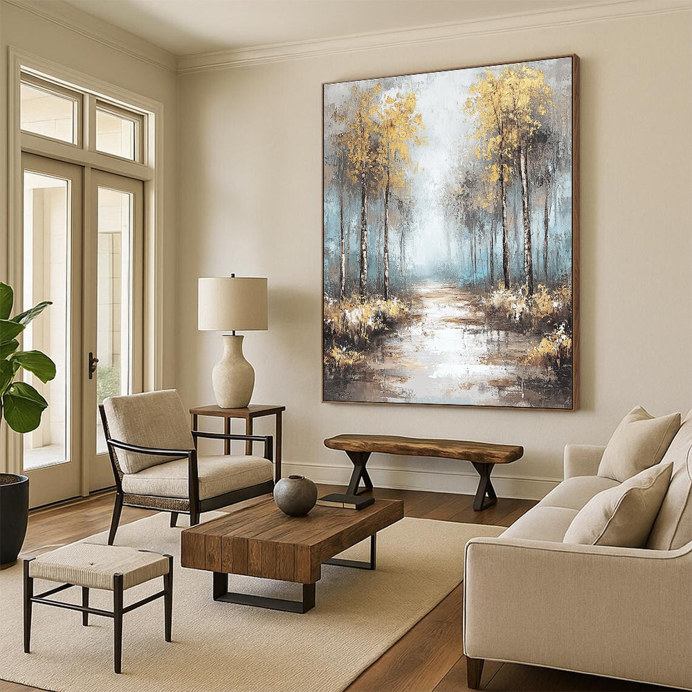 Large abstract painting featuring soft blues and grays with gold leaf accents creating a tranquil misty forest landscape.STSC060
