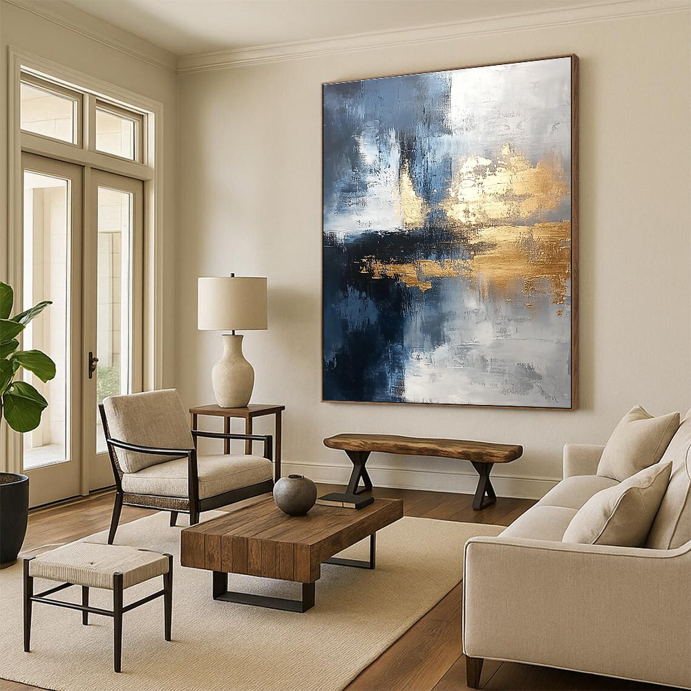 Large abstract painting blending silver and gold with gray blue tones and light brushstrokes featuring exquisite details and a unique composition for a calming atmosphere.STSC376