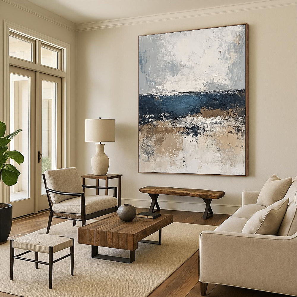 Large abstract painting of the sea in gray and blue tones with accents of beige brown and white for a serene artistic touch.STSC343