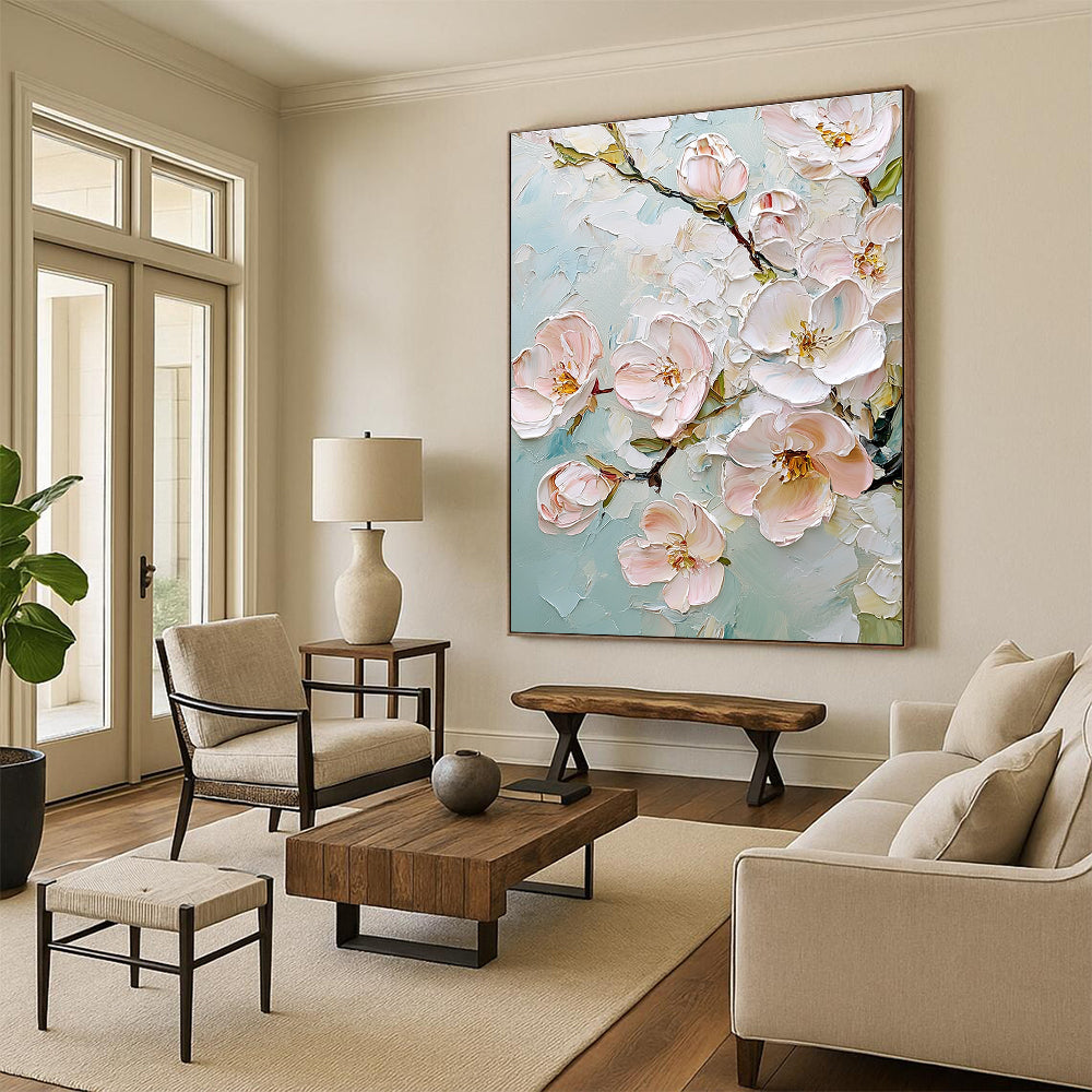 Large abstract painting featuring delicate cherry blossoms in soft pink and white against a light blue background with rich impasto texture.STSC875