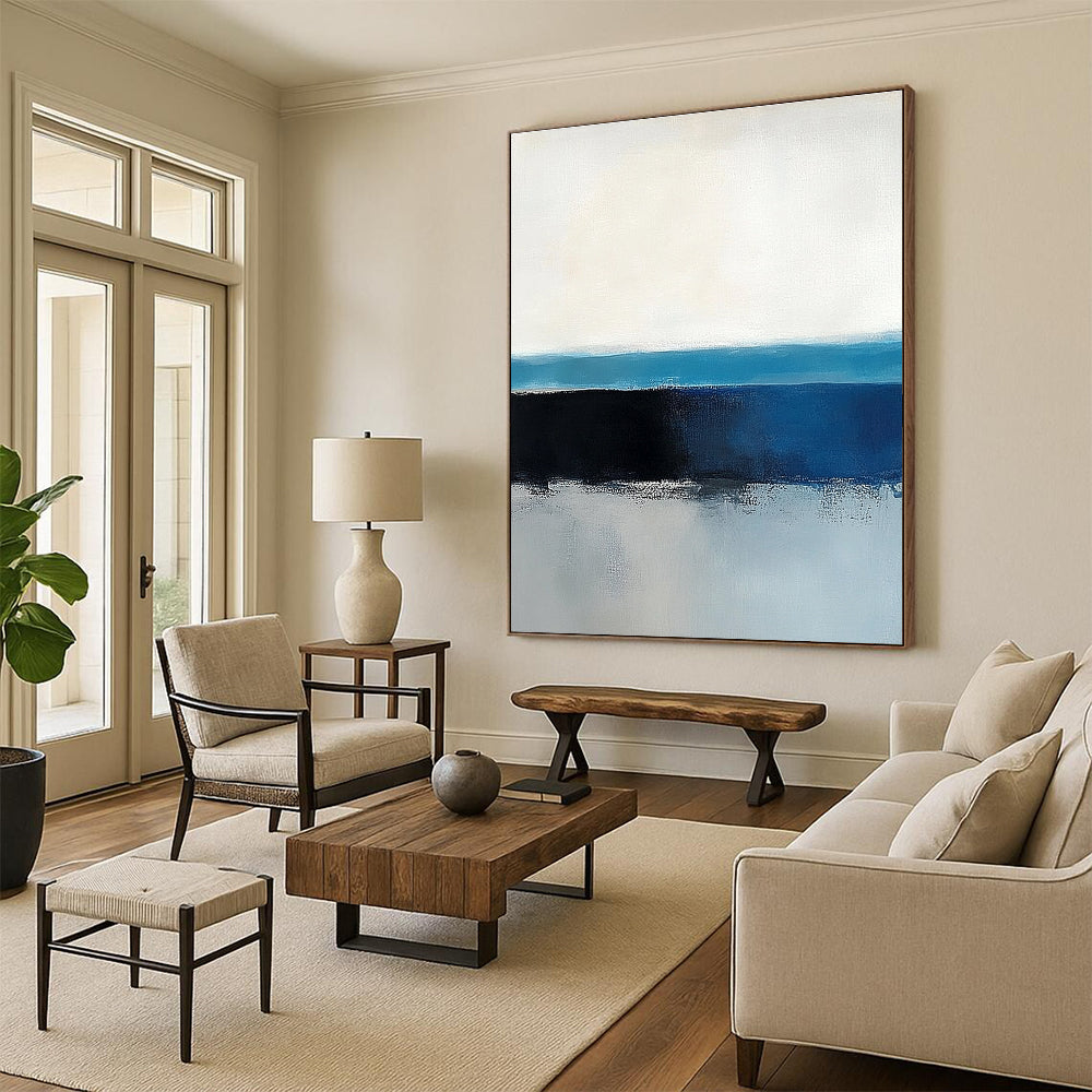 Large abstract painting of the ocean horizon featuring blue and gray tones in a minimalist style with neutral colors.STSC342