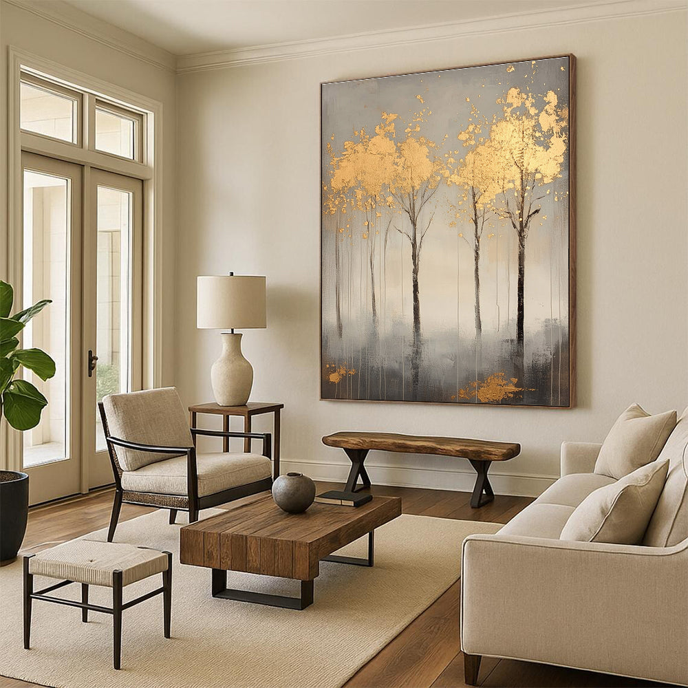 A large abstract painting featuring serene gray trees with gold leaf accents creating a tranquil atmosphere and evoking nature's beauty.STSC1174