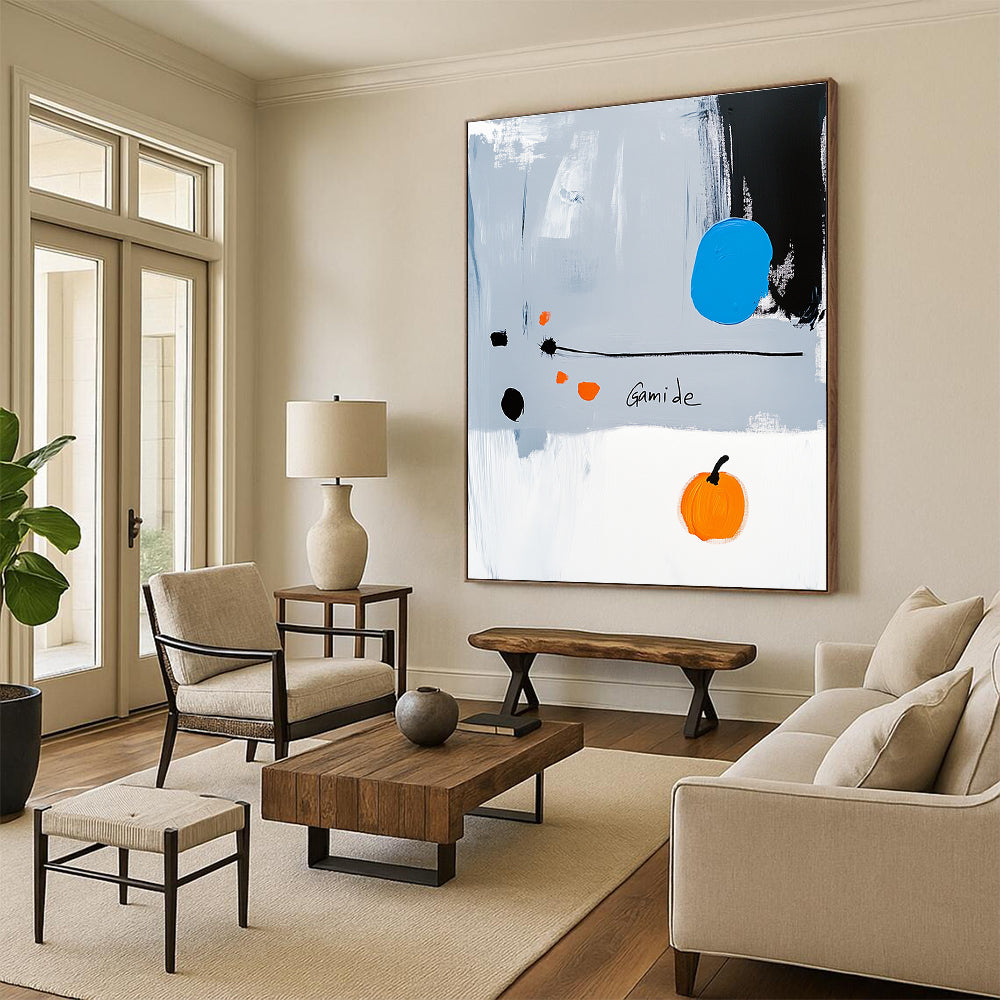 Abstract painting of a right-pointing arrow in blue white gray orange and black with Gamide text and a cartoonish pumpkin on light gray background.STSC1073
