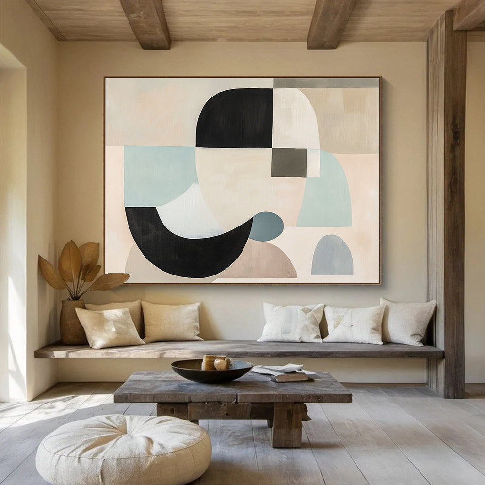 Large abstract painting with white, black, and grey shapes in soft pastel colors featuring geometric forms and a neutral beige background.SC510
