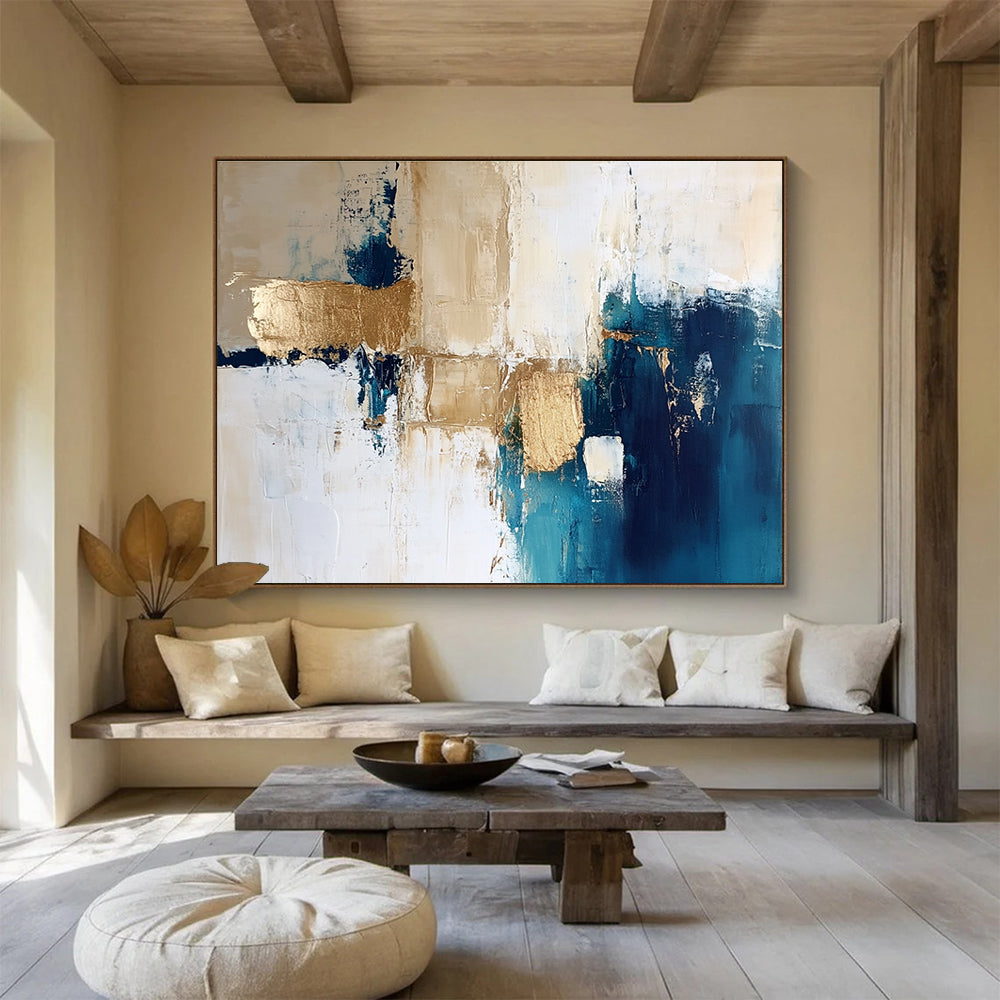 Large abstract painting in blue and gold with white beige and cream tones ideal for modern decor and artistic spaces.SC024