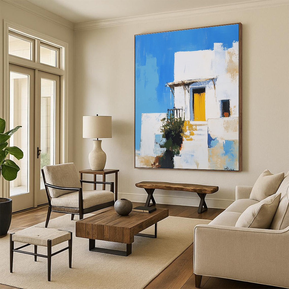 An abstract painting featuring a white Greek-style house with a yellow door against a blue sky inspired by Peter Wileman.STSC1253
