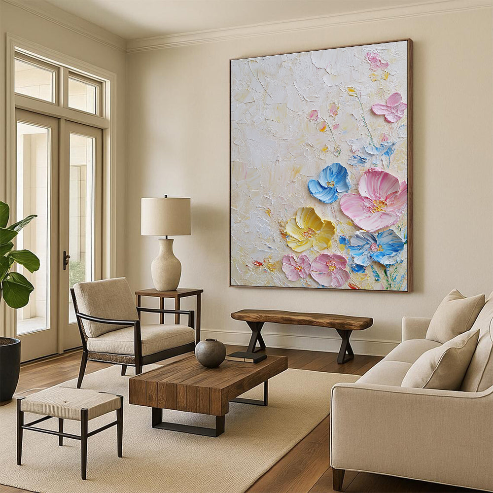 Large abstract painting with textured layers featuring pastel flowers in pink and blue on a white background illuminated by soft lighting.STSC1366