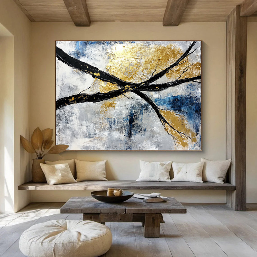 Abstract painting featuring black and white branches with gold leaf accents against a serene blue sky background.SC367