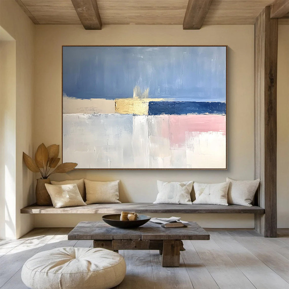 Large abstract painting featuring soft blue skies, pale pink horizons, gold highlights, and a tranquil sea in muted tones.SC025