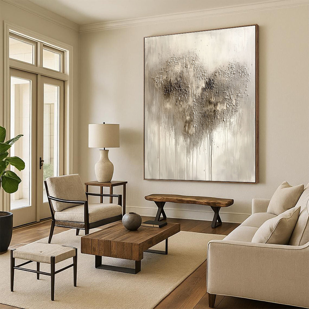 Large abstract painting in silvery gray with impasto texture featuring a heart-shaped pattern and accents of black and dark brown.STSC519