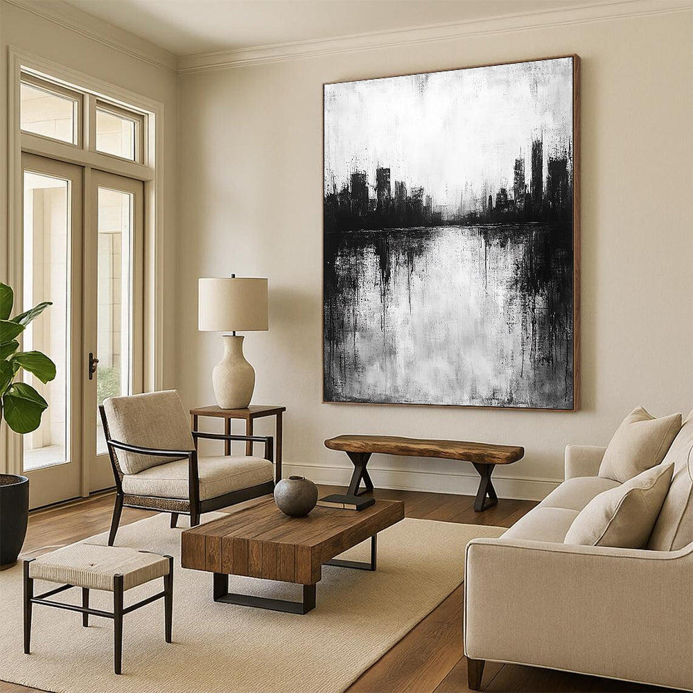 Large abstract painting in black and white with city silhouette and lake reflection evokes calmness and mystery through minimalist heavy brushstrokes.STSC215