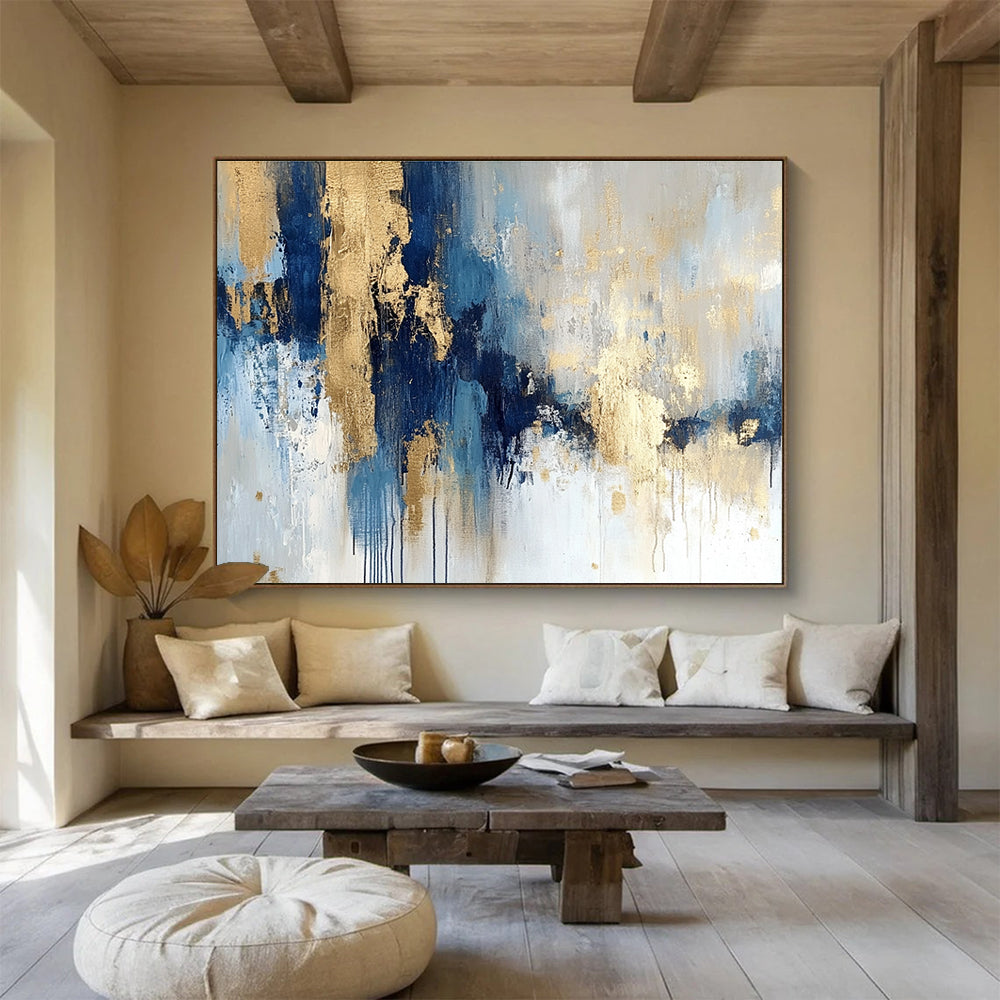 Large abstract painting in blue and gold with soft edges and texture featuring modern elegance and movement on a white background.SC021