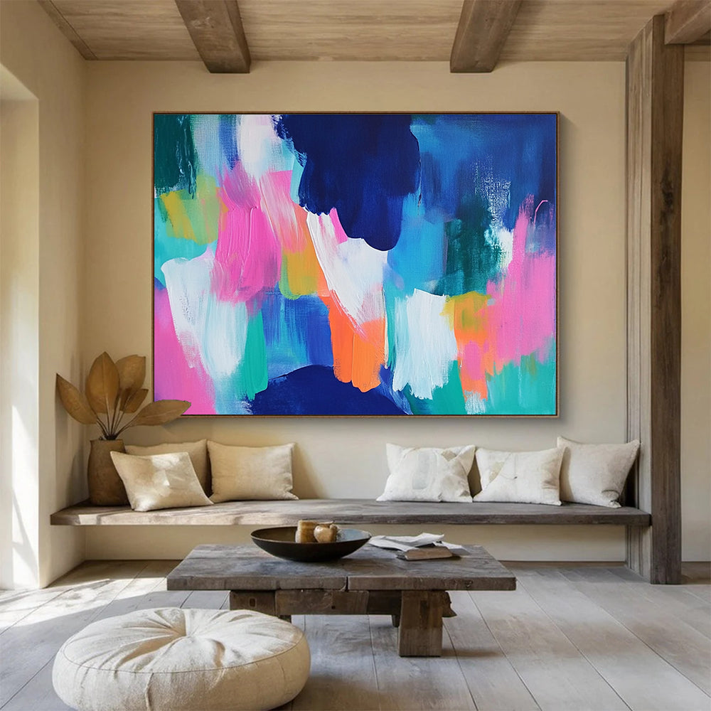 A large abstract painting with bold blue and pink backgrounds and bright orange, green, and turquoise foregrounds, conveying energy and movement.SC562