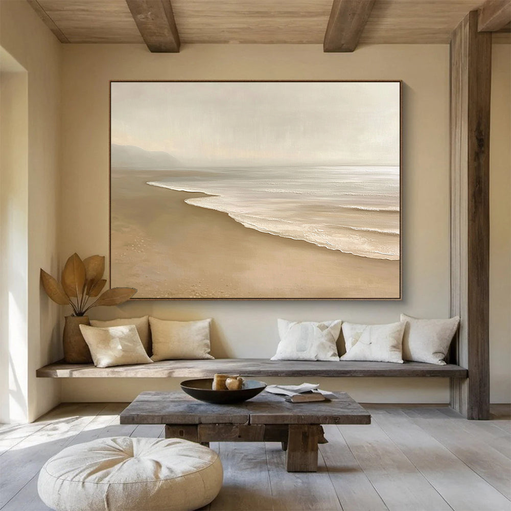 Large abstract painting featuring a serene beach with beige and white tones capturing gentle waves and soft sand in a tranquil setting.SC424