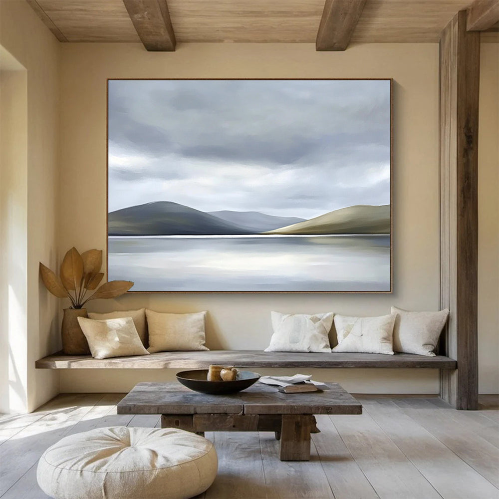 Large abstract painting of the Scottish Highlands featuring muted colors soft light grey sky white clouds and a serene lake in the foreground.SC131