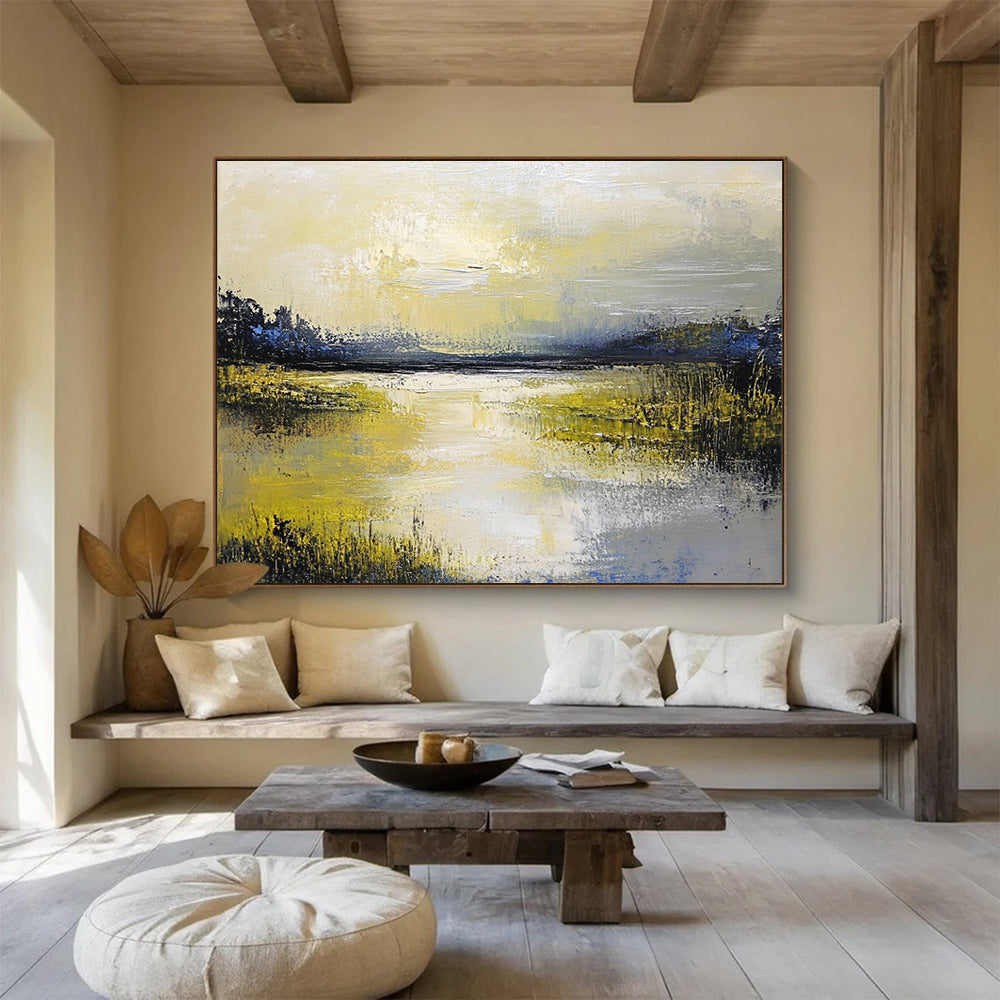 Large abstract painting featuring a serene lake and sky in soft yellow green blue and gray tones with thick textured paint.SC078