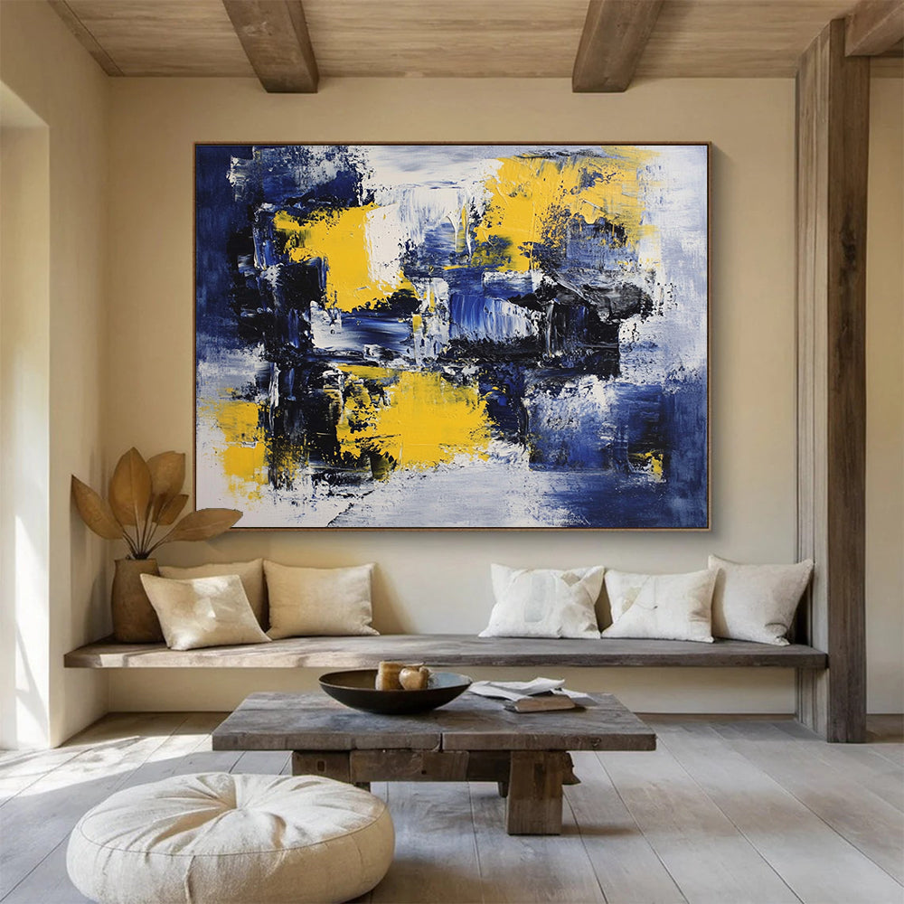 Large abstract painting featuring deep blue, white, and yellow accents with impressionist brush strokes on canvas ideal for modern wall decor.SC031