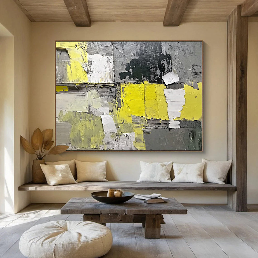 Large abstract painting featuring gray and yellow hues with textured paper elements extending from the wall for added dimension.SC240