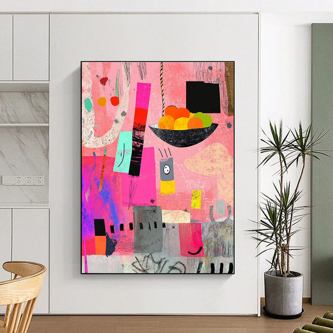 A large abstract painting featuring pink gray and black shapes with a bowl of fruits colorful scribbles and artistic texture elements.STSC969
