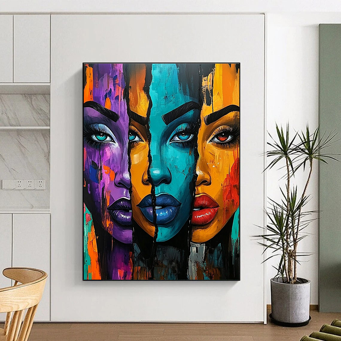 A large abstract painting featuring three vibrant African American women with bold colors and expressive features set against an energetic urban-inspired background.STSC1220
