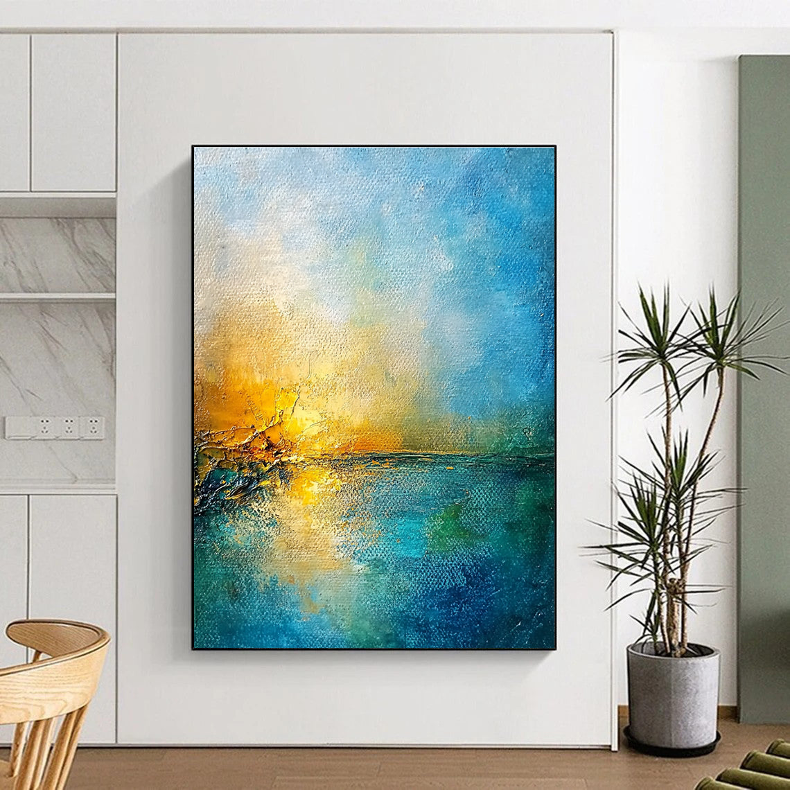 Large abstract painting of a golden sunset over a blue sea featuring textured canvas and rustic-core style nature-inspired colors.STSC165