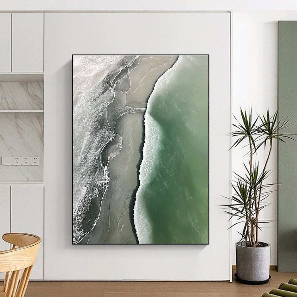 Abstract art piece featuring an aerial view of a beach with green and gray waves flowing onto white sandy shores.STSC529