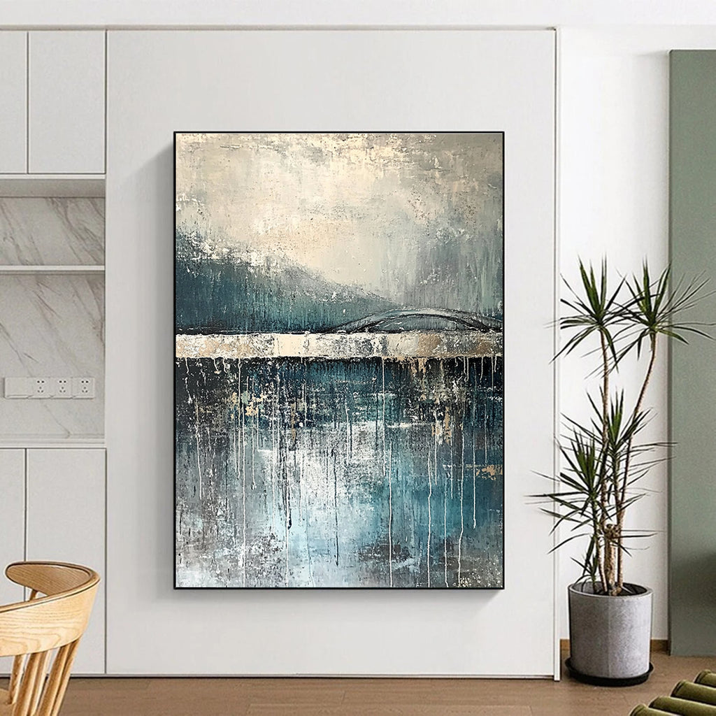 Large abstract painting depicting rain reflections on water with an old bridge in gray and blue tones accented with silver on textured canvas.STSC326