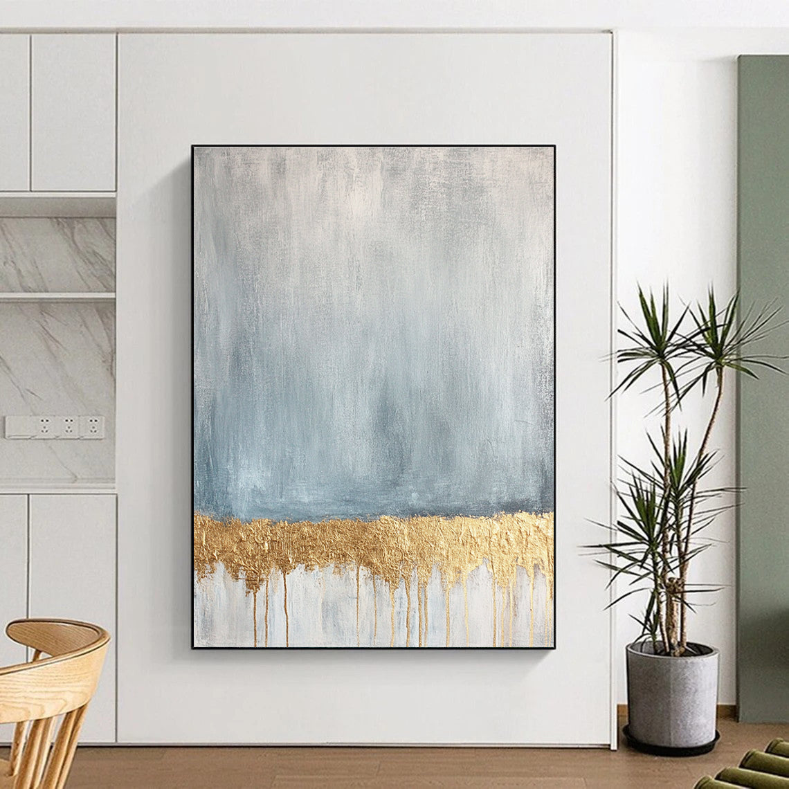 Large abstract painting featuring a textured pale blue and gold palette with a gold metallic foil line across a soft grey and white background.STSC571