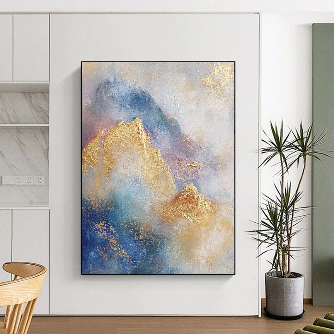 Large abstract painting featuring soft blue and gold tones with gilded mountains and textured brushstrokes for a striking visual impact.STSC446